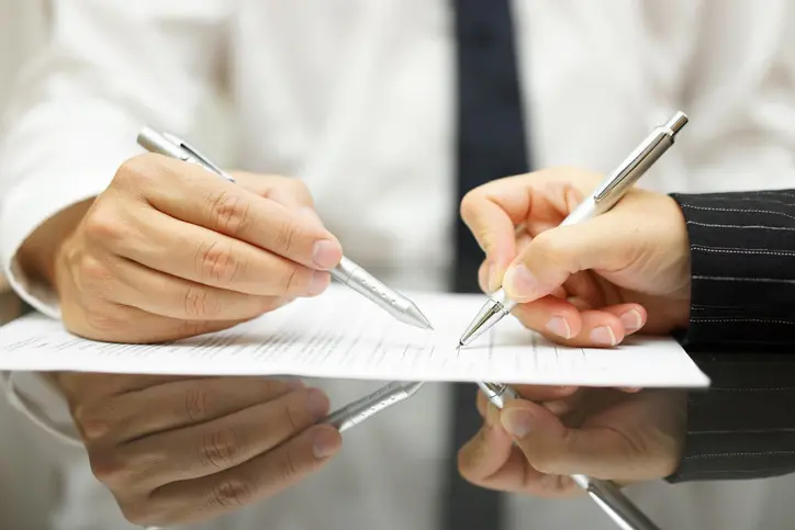 Personas firmando un documento
